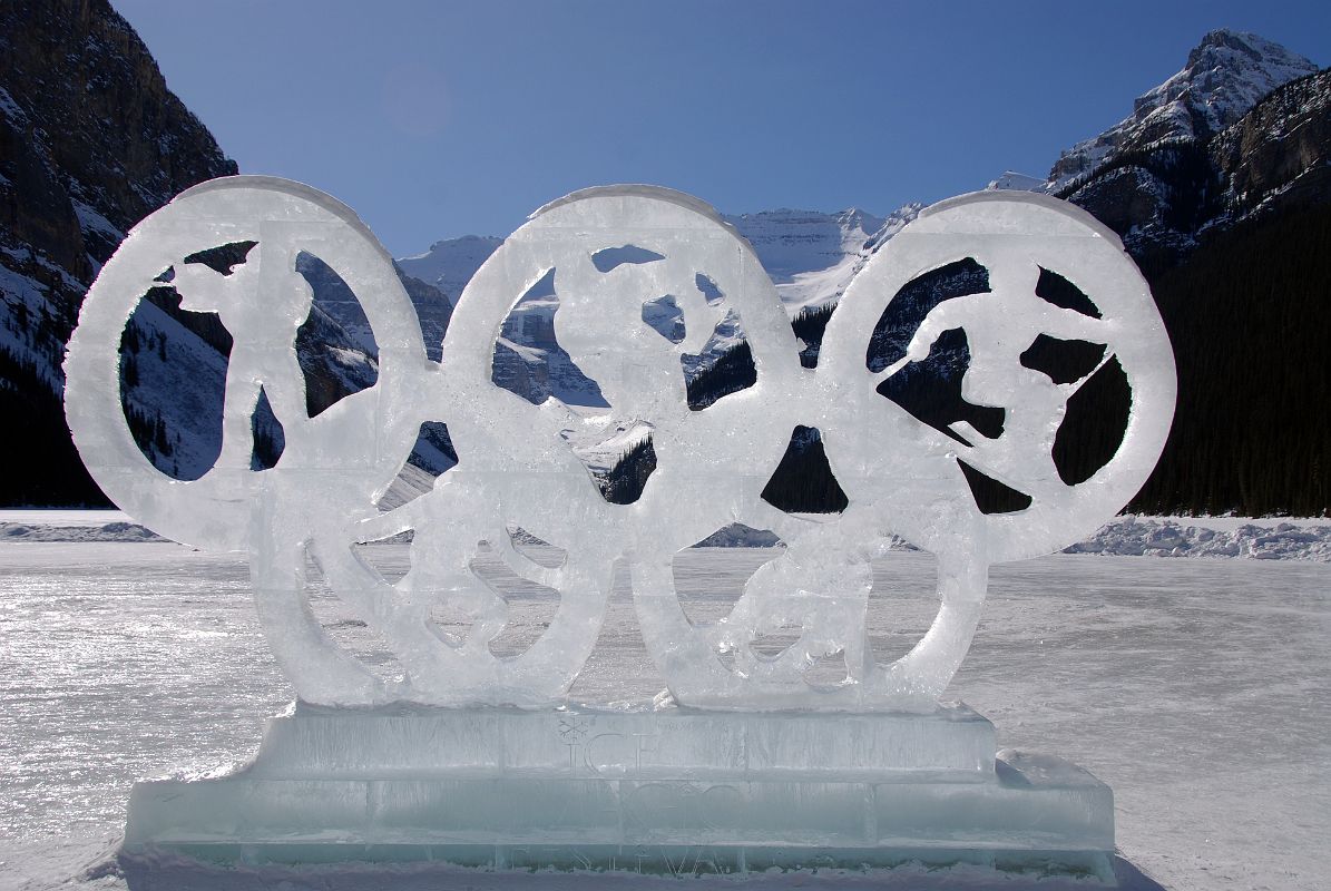 24A Olympic Rings Ice Sculpture On Frozen Lake Louise With Mount Victoria and Mount Whyte Behind